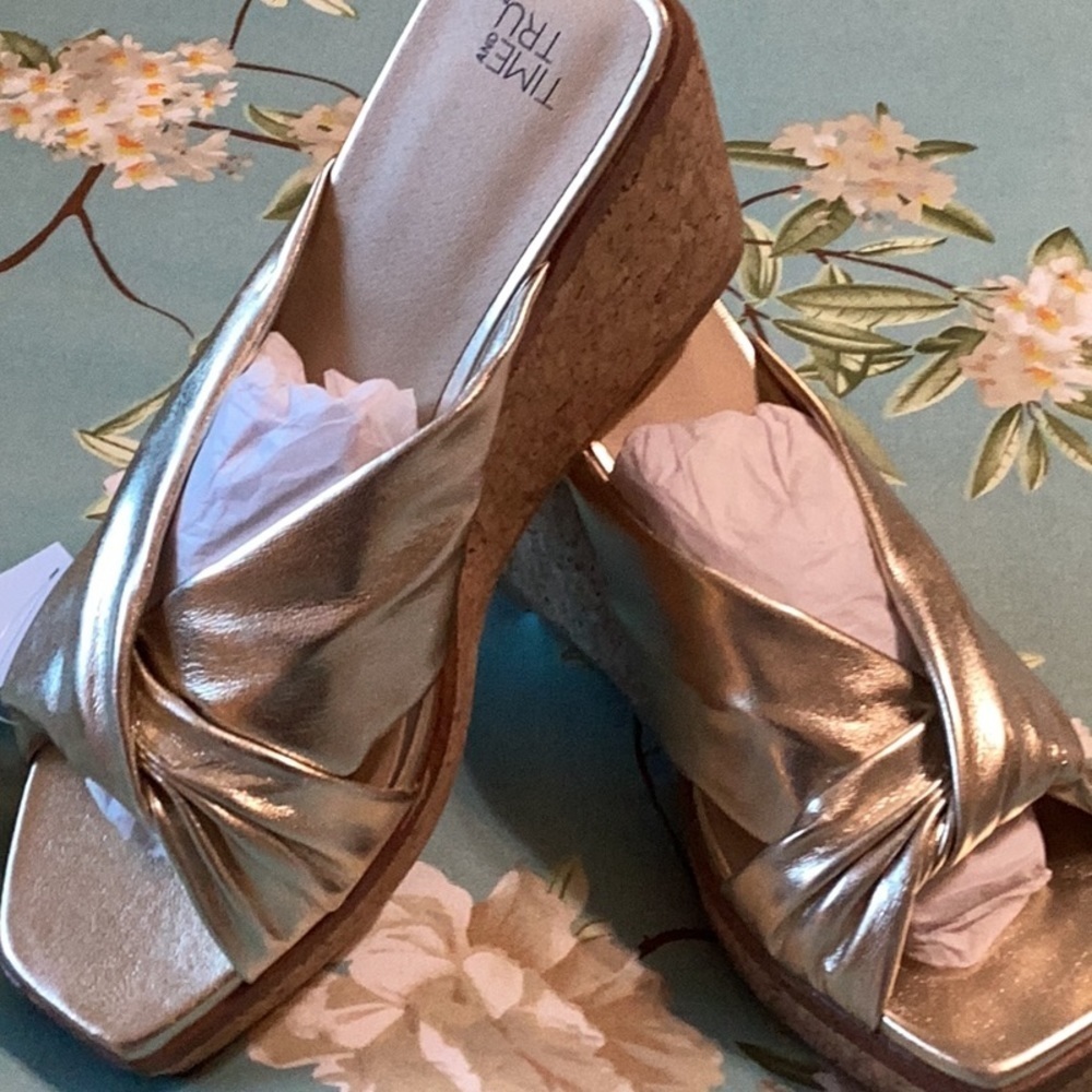 Women’s size 8 gold wedge sandals.